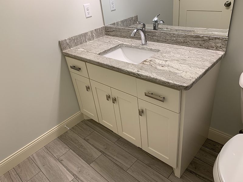 custom bathroom sink with granite countertop and silver faucet 