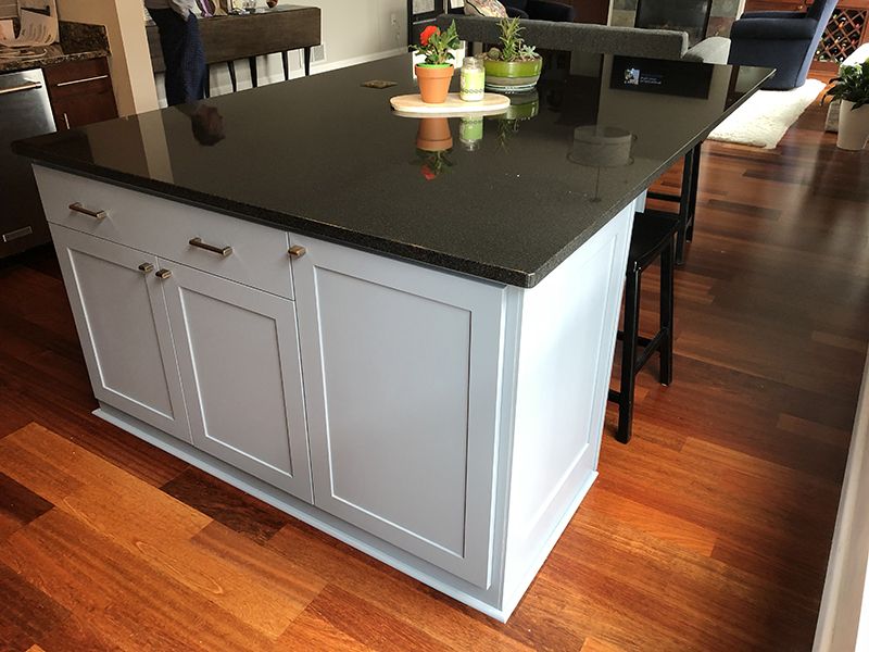 black granite kitchen countertop island with white cabinets 